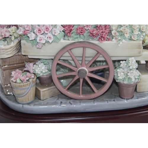 357 - LLADRO FLOWER SELLER 
27 X 33CM COUPLE OF FLOWERS ARE A/F