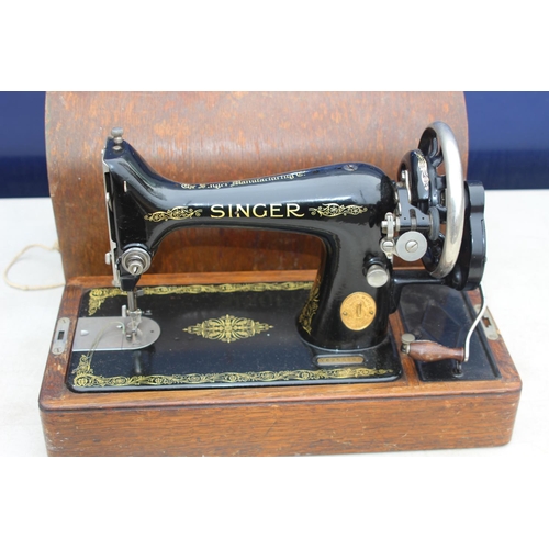 664 - SINGER SEWING MACHINE WITH KEY