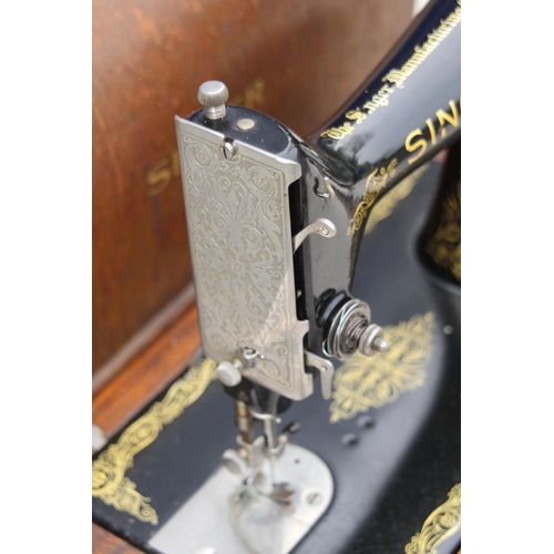 664 - SINGER SEWING MACHINE WITH KEY