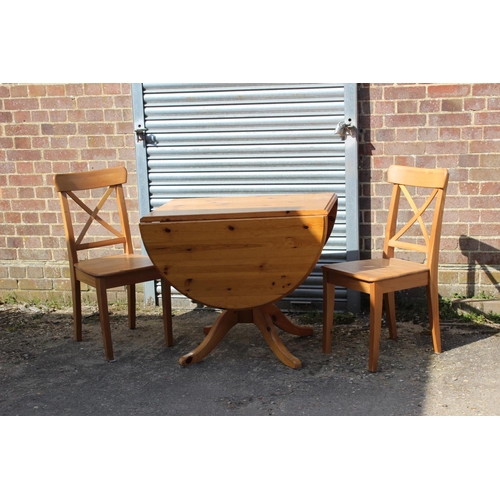 57 - PINE DROP LEAF TABLE AND TWO CHAIRS 
134 X 90 X 77CM