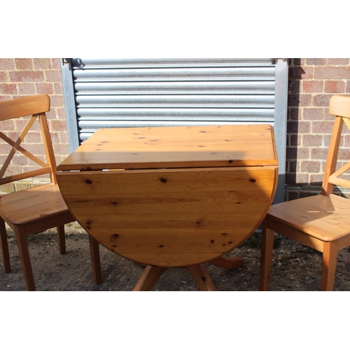 57 - PINE DROP LEAF TABLE AND TWO CHAIRS 
134 X 90 X 77CM