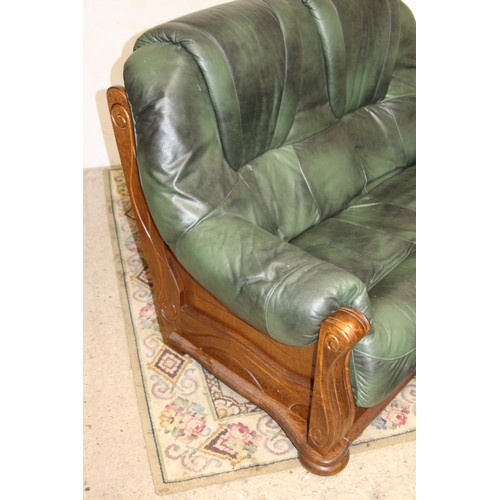 27 - GREEN LEATHER AND WOOD SOFA AND STOOL