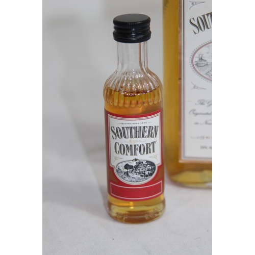 543 - HALF BOTTLE AND MINIATURE OF SOUTHERN COMFORT