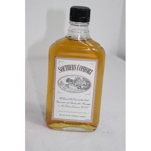 543 - HALF BOTTLE AND MINIATURE OF SOUTHERN COMFORT