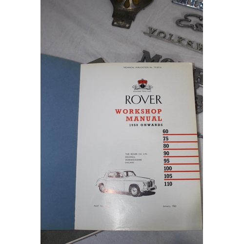 879 - 2 X VINTAGE MANUALS AND CAR BADGES