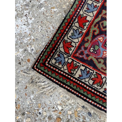 121 - VINTAGE EASTERN RUG
110 X 85CM