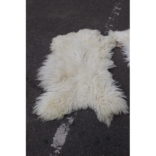 129 - 2 X SHEEPSKIN RUGS 
90 X 62CM