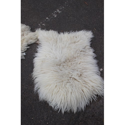 129 - 2 X SHEEPSKIN RUGS 
90 X 62CM