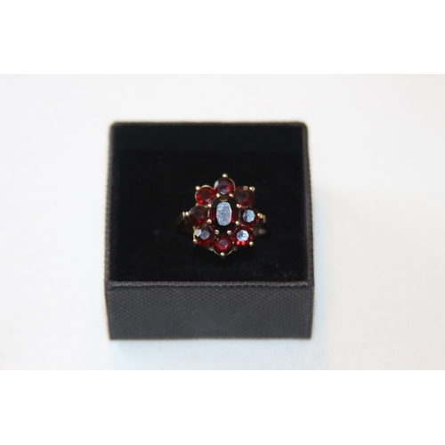 805 - 9CT GOLD RING WITH 9 GARNET CLUSTER DESIGN - 4.08G - RUBBED LONDON MARKS BY C LTD