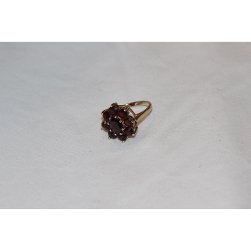 805 - 9CT GOLD RING WITH 9 GARNET CLUSTER DESIGN - 4.08G - RUBBED LONDON MARKS BY C LTD