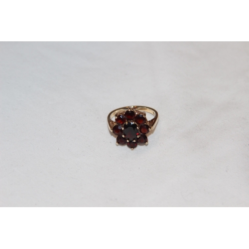 805 - 9CT GOLD RING WITH 9 GARNET CLUSTER DESIGN - 4.08G - RUBBED LONDON MARKS BY C LTD