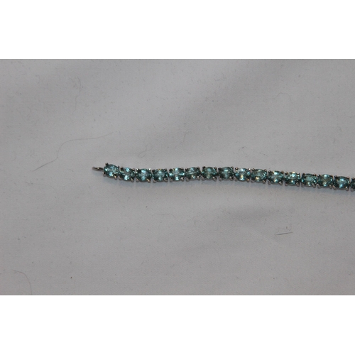 688 - SILVER BRACELET WITH AQUA COLOURED STONES