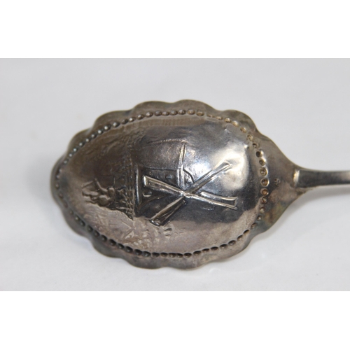 730 - DUTCH SILER WINE OR CADDY SPOON WITH WINDMILL DECORATION TO BOWL AND AN ARCHER ON THE STEM