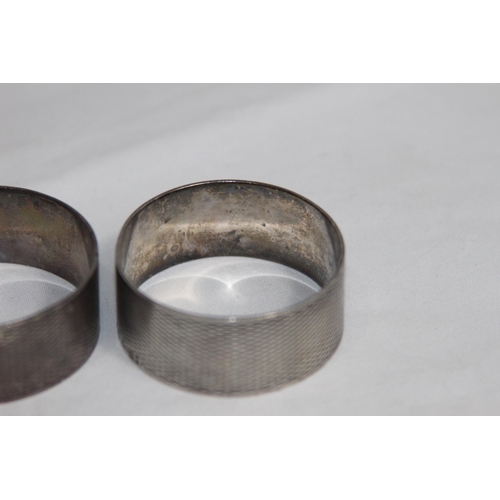 752 - PAIR OF ROUND SILVER NAPKIN RINGS WITH ENGINE TURNED FINISH - VACANT CARTOUCHES - BIRMINGHAM 1978