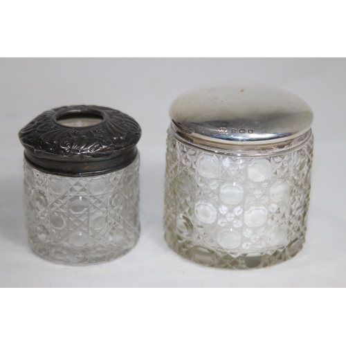 770 - TWO SILVER TOPPED VANITY JARS - BIRMINGHAM 1905 AND 1921