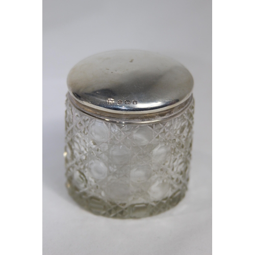 770 - TWO SILVER TOPPED VANITY JARS - BIRMINGHAM 1905 AND 1921