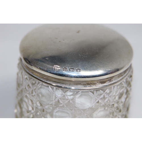 770 - TWO SILVER TOPPED VANITY JARS - BIRMINGHAM 1905 AND 1921