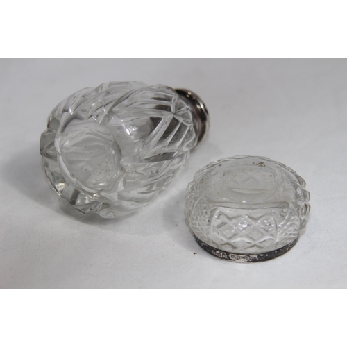 779 - SILVER TOPPED PEPPER POT AND SILVER RIMMED SALT