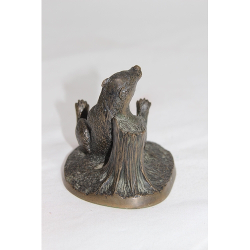 610 - BRONZE MODEL OF A BADGER LEANING AGAIST A TREE TRUNK