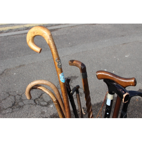 307 - QUANTITY OF WALKING STICKS INCLUDING CARVED ELEPHANT AND TURNED SHAFT VERSION IN A COPPER STICK STAN... 