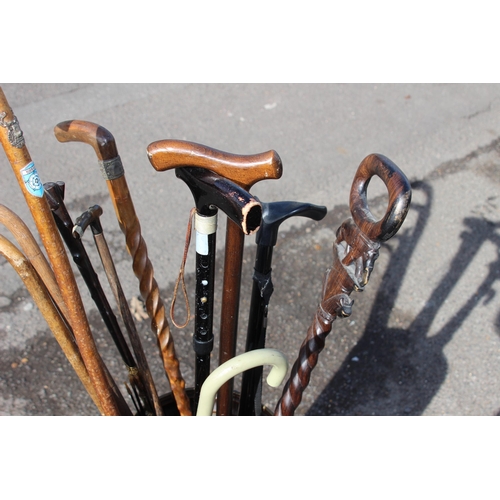 307 - QUANTITY OF WALKING STICKS INCLUDING CARVED ELEPHANT AND TURNED SHAFT VERSION IN A COPPER STICK STAN... 