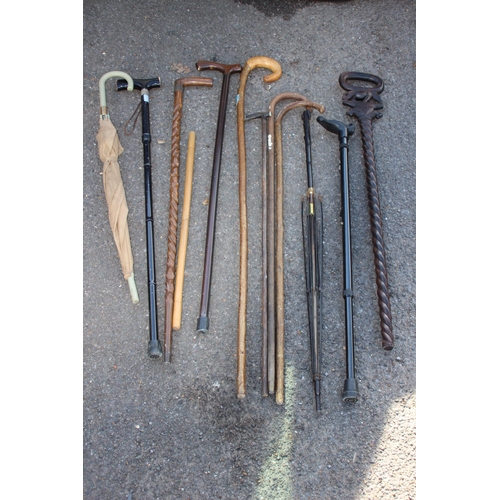 307 - QUANTITY OF WALKING STICKS INCLUDING CARVED ELEPHANT AND TURNED SHAFT VERSION IN A COPPER STICK STAN... 