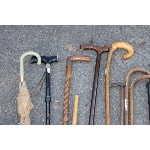 307 - QUANTITY OF WALKING STICKS INCLUDING CARVED ELEPHANT AND TURNED SHAFT VERSION IN A COPPER STICK STAN... 