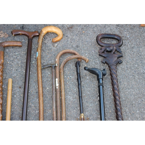 307 - QUANTITY OF WALKING STICKS INCLUDING CARVED ELEPHANT AND TURNED SHAFT VERSION IN A COPPER STICK STAN... 