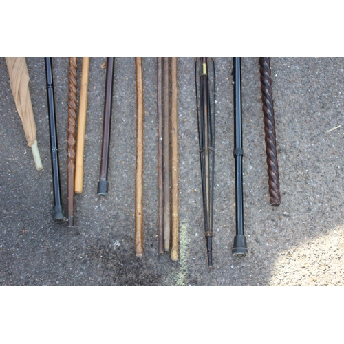 307 - QUANTITY OF WALKING STICKS INCLUDING CARVED ELEPHANT AND TURNED SHAFT VERSION IN A COPPER STICK STAN... 