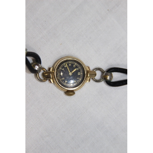 1190 - 9CT GOLD WRISTWATCH AND A YELLOW METAL LOCKET