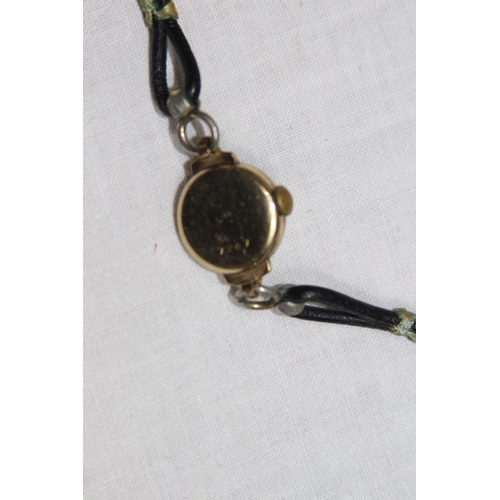 1190 - 9CT GOLD WRISTWATCH AND A YELLOW METAL LOCKET