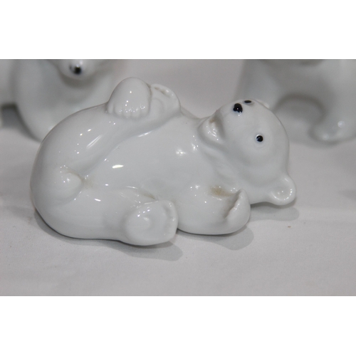 838 - 4 X PORCELIAN POLAR BEAR CUB FIGURES
9CM