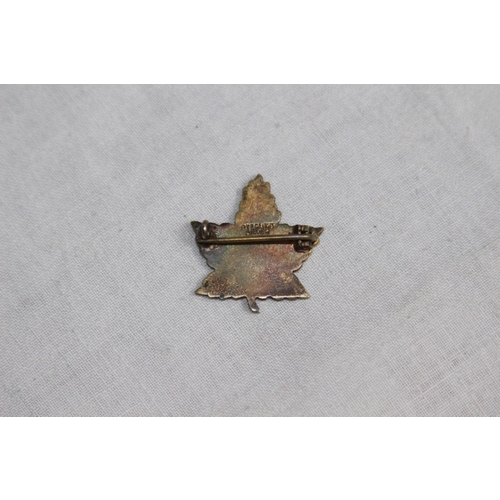 819 - MILITARY CONVALESCENT HOSPITAL EPSOM SILVER AND ENAMEL BADGE IN MAPLE LEAF FORM