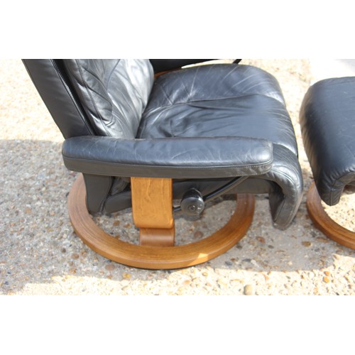 69 - EKORNES BLACK LEATHER RECLINING STRESSLESS CHAIR AND FOOT STOOL 
84 X 70 X 102CM