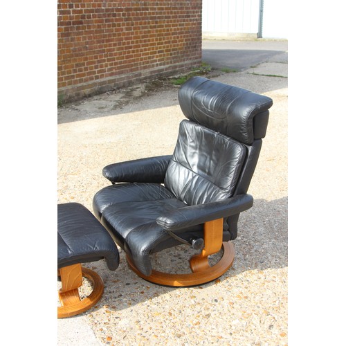 69 - EKORNES BLACK LEATHER RECLINING STRESSLESS CHAIR AND FOOT STOOL 
84 X 70 X 102CM