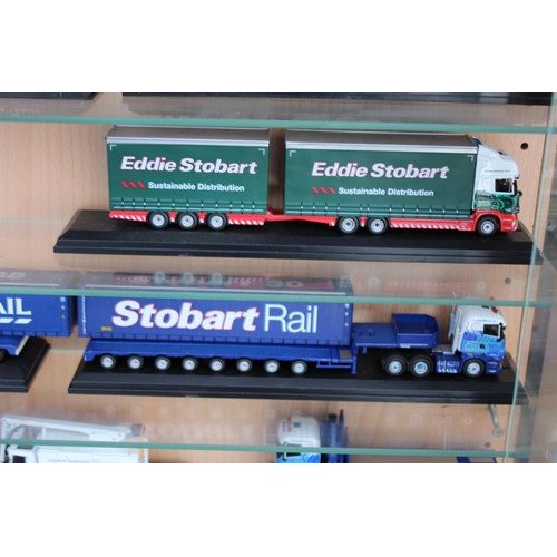 598 - LARGE DISPLAY CABINET WITH EDDIE STOBART TRUCKS  x30
65 X 19 X 113CM