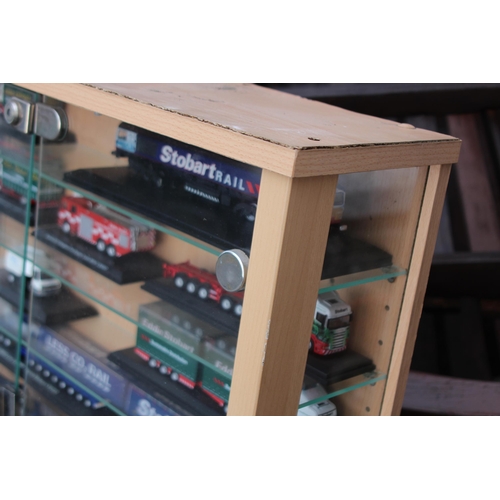 598 - LARGE DISPLAY CABINET WITH EDDIE STOBART TRUCKS  x30
65 X 19 X 113CM