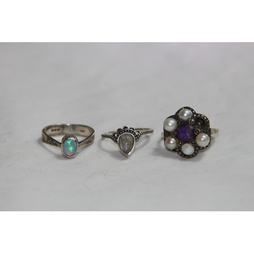 950 - THREE SILVER RINGS ONE SET WITH AN OPAL