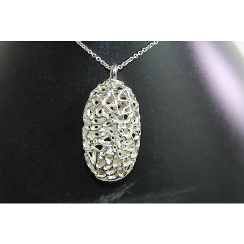 951 - VERY LARGE SILVER PENDANT NECKLACE OF PIERCED OVAL DESIGNS