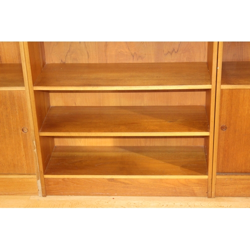 24 - THREE 1970'S TEAK WALL UNITS 
48 X 38 X 104
233 ALTOGETHER