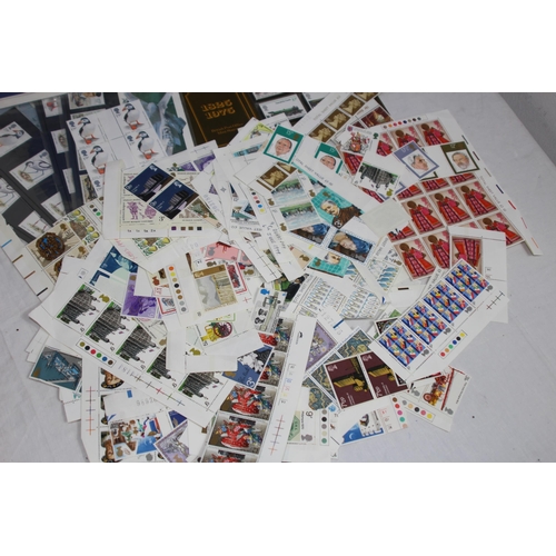 295 - AN ALBUM OF 1ST DAY COVERS AND A LARGE QUANTITY OF UNUSED BRITISH STAMPS IN EXCESS OF £40