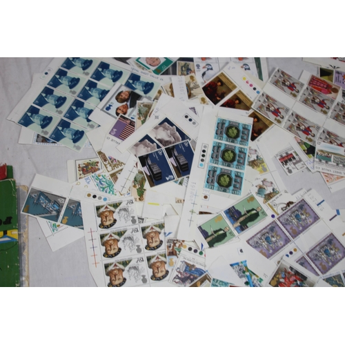 295 - AN ALBUM OF 1ST DAY COVERS AND A LARGE QUANTITY OF UNUSED BRITISH STAMPS IN EXCESS OF £40