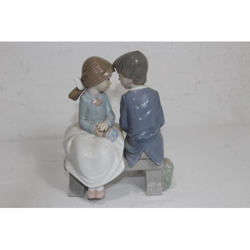 855 - NAO FIGURE OF A YOUNG COUPLE SITTING ON A BENCH
16.5 X 13CM