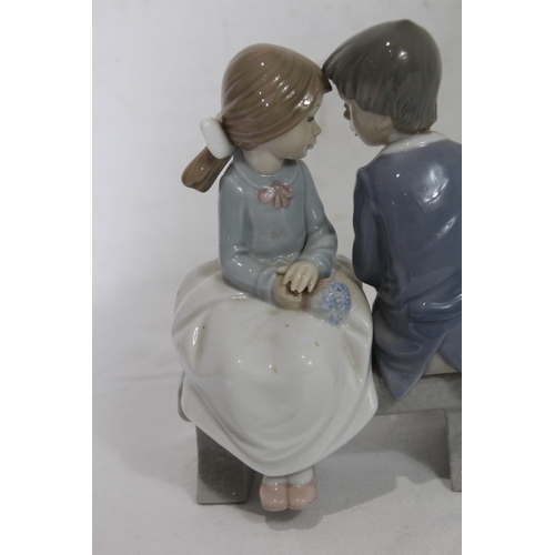 855 - NAO FIGURE OF A YOUNG COUPLE SITTING ON A BENCH
16.5 X 13CM