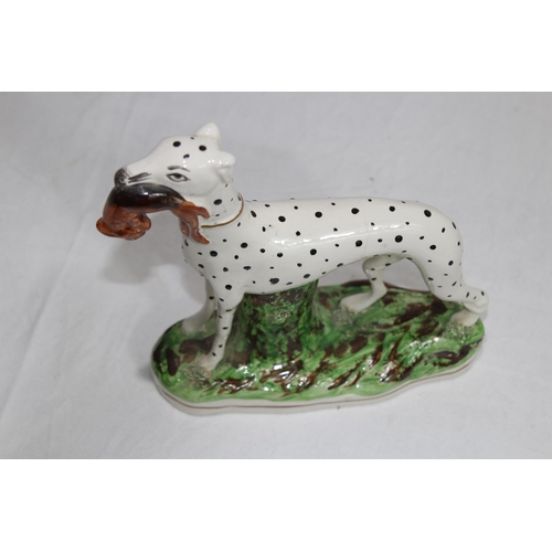 864 - STAFFORDSHIRE DOG WITH HARE 
19 X 18CM