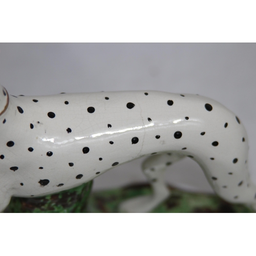 864 - STAFFORDSHIRE DOG WITH HARE 
19 X 18CM