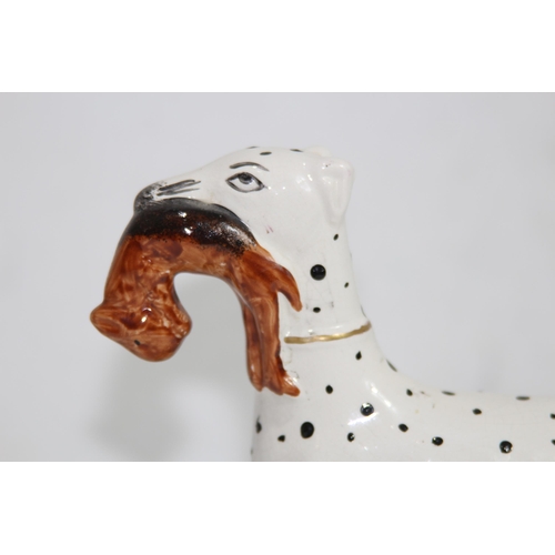 864 - STAFFORDSHIRE DOG WITH HARE 
19 X 18CM