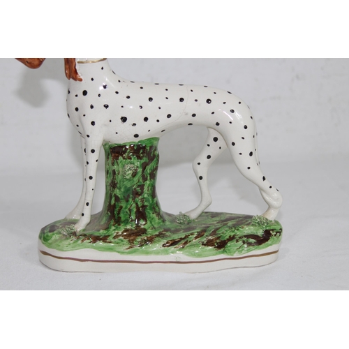 864 - STAFFORDSHIRE DOG WITH HARE 
19 X 18CM