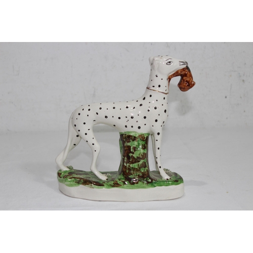 864 - STAFFORDSHIRE DOG WITH HARE 
19 X 18CM