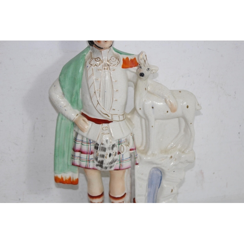 308 - STAFFORDSHIRE STYLE FIGURE OF A SCOTTISH HUNTSMAN - A/F
46CM